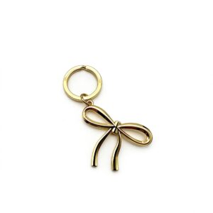 High-end mirror-polished light gold bowknot keychain and ribbon bag charm, custom OEM manufactured by Wahkoi Metal.