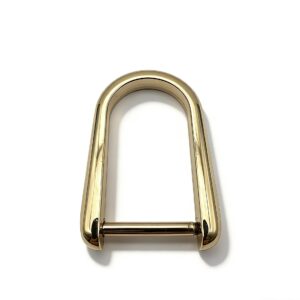 High-end mirror-polished light gold elongated D-ring horseshoe shackle with removable screw bar for luxury leather bags, custom OEM manufactured by Wahkoi Metal.