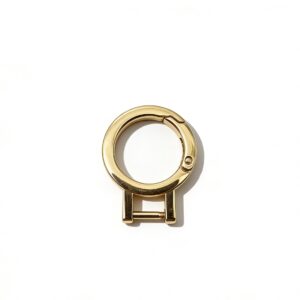 High-end mirror-polished light gold spring gate ring carabiner with a screw-in bottom bar for interchangeable luxury bag straps, custom OEM manufactured by Wahkoi Metal.