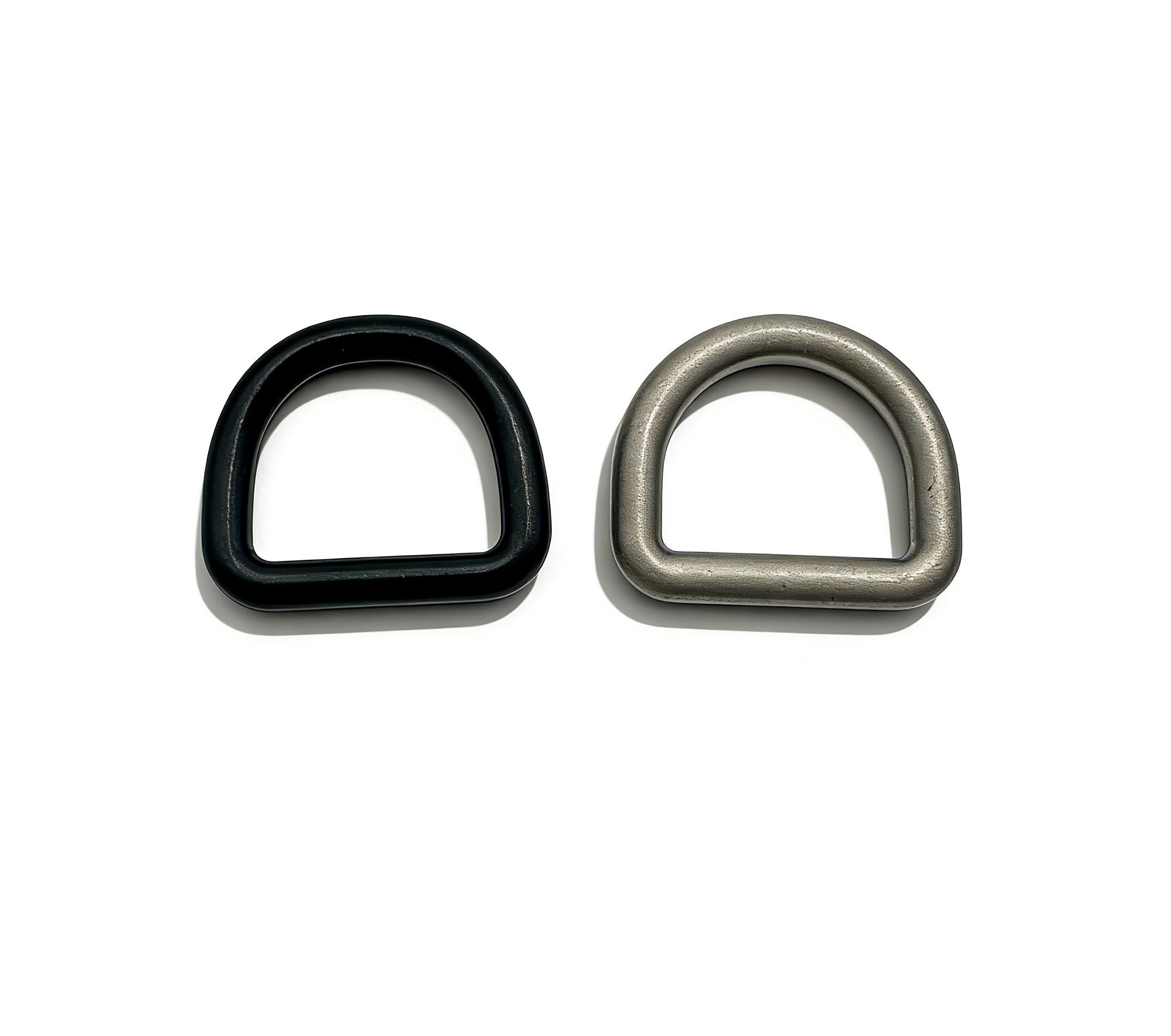 High-end solid D-rings featuring tactical matte black and heritage antique silver finishes for premium leathercraft and techwear, custom OEM manufactured by Wahkoi Metal.