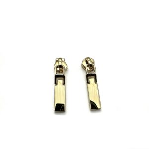 High-end mirror-polished light gold solid bar zipper pull and minimalist zip slider attachment for luxury handbags and high-fashion apparel, custom OEM manufactured by Wahkoi Metal.