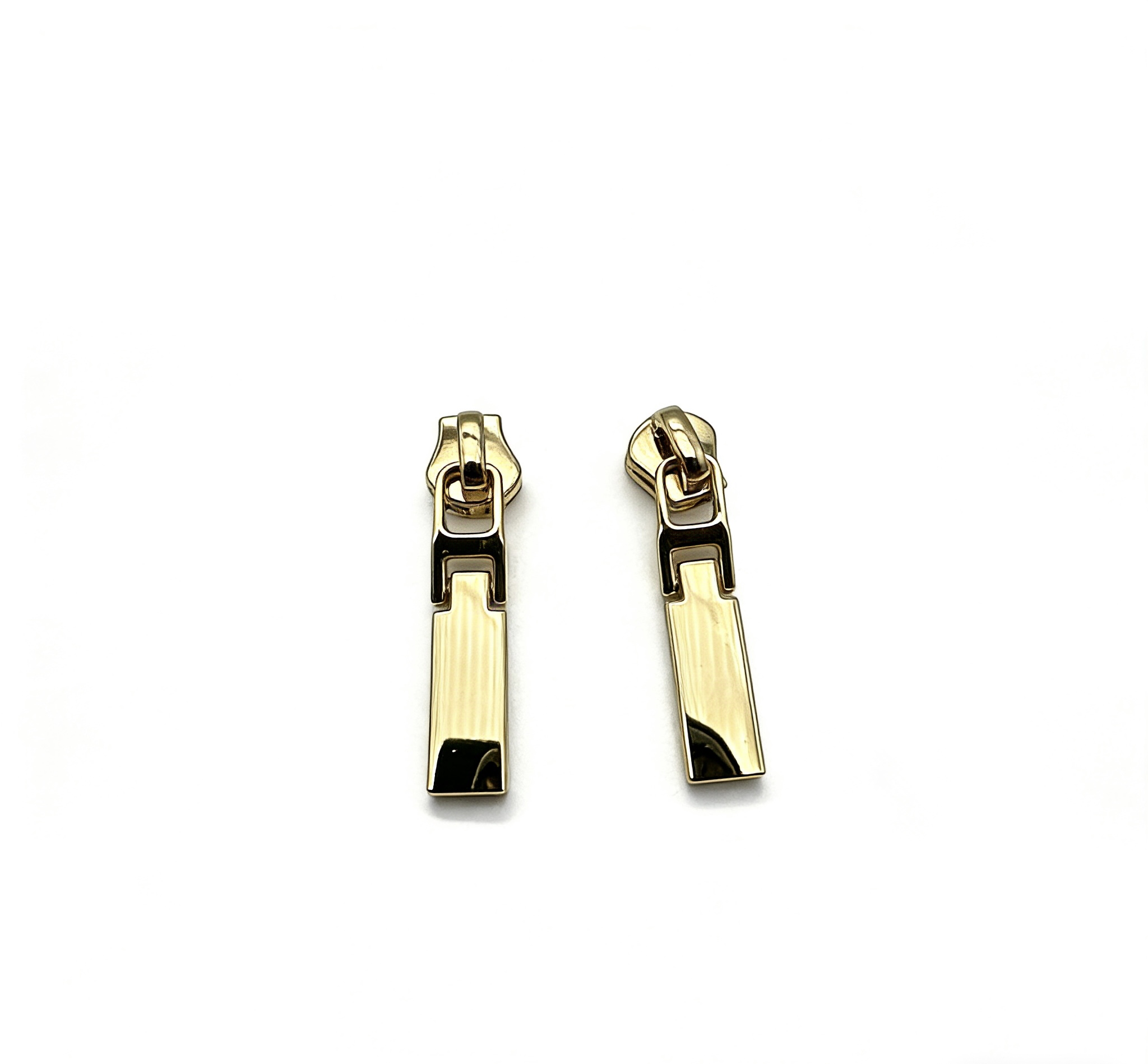 High-end mirror-polished light gold solid bar zipper pull and minimalist zip slider attachment for luxury handbags and high-fashion apparel, custom OEM manufactured by Wahkoi Metal.