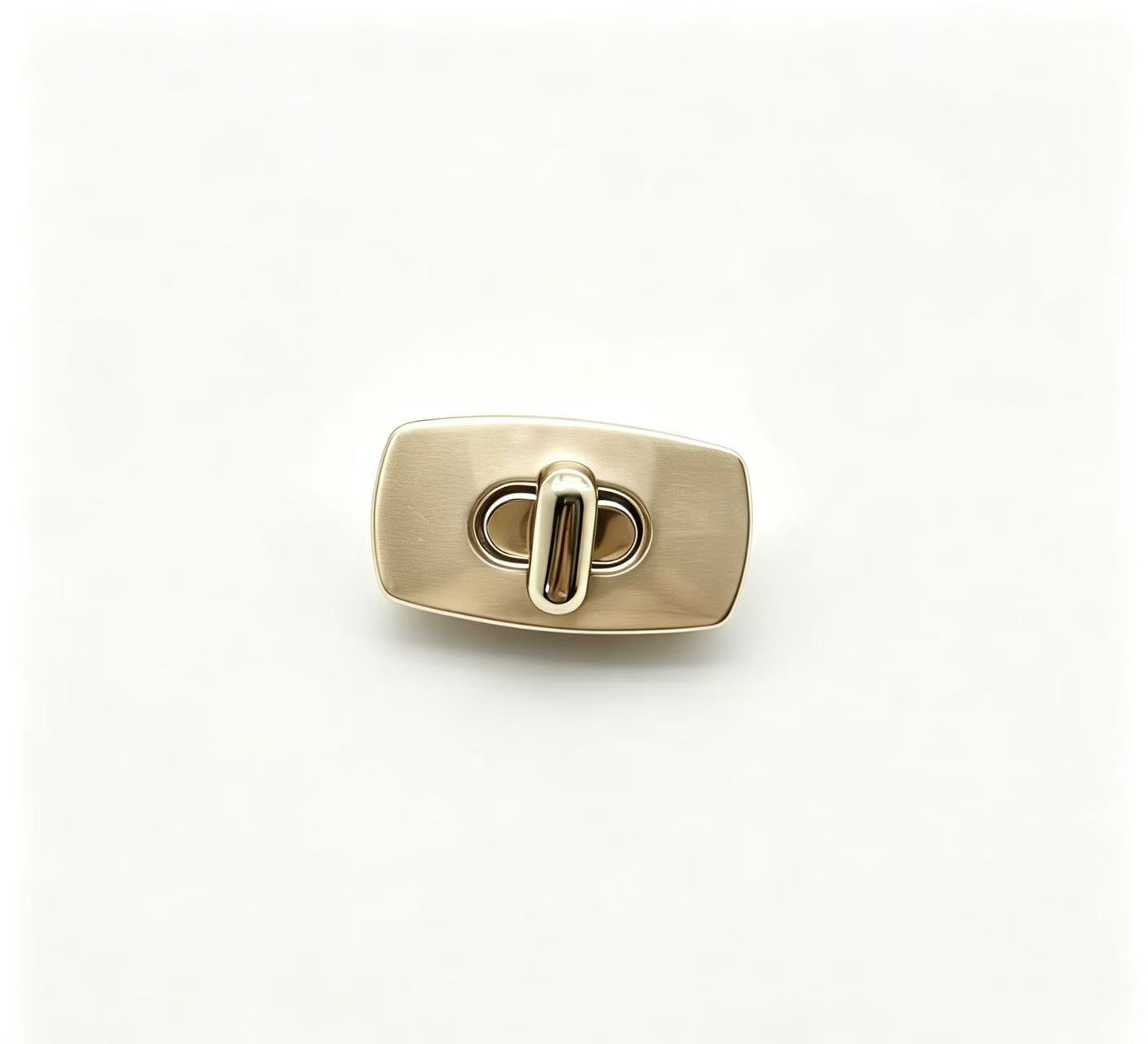 Premium brushed gold zinc alloy rectangular turn lock for luxury handbags, custom manufactured by Wahkoi Metal.