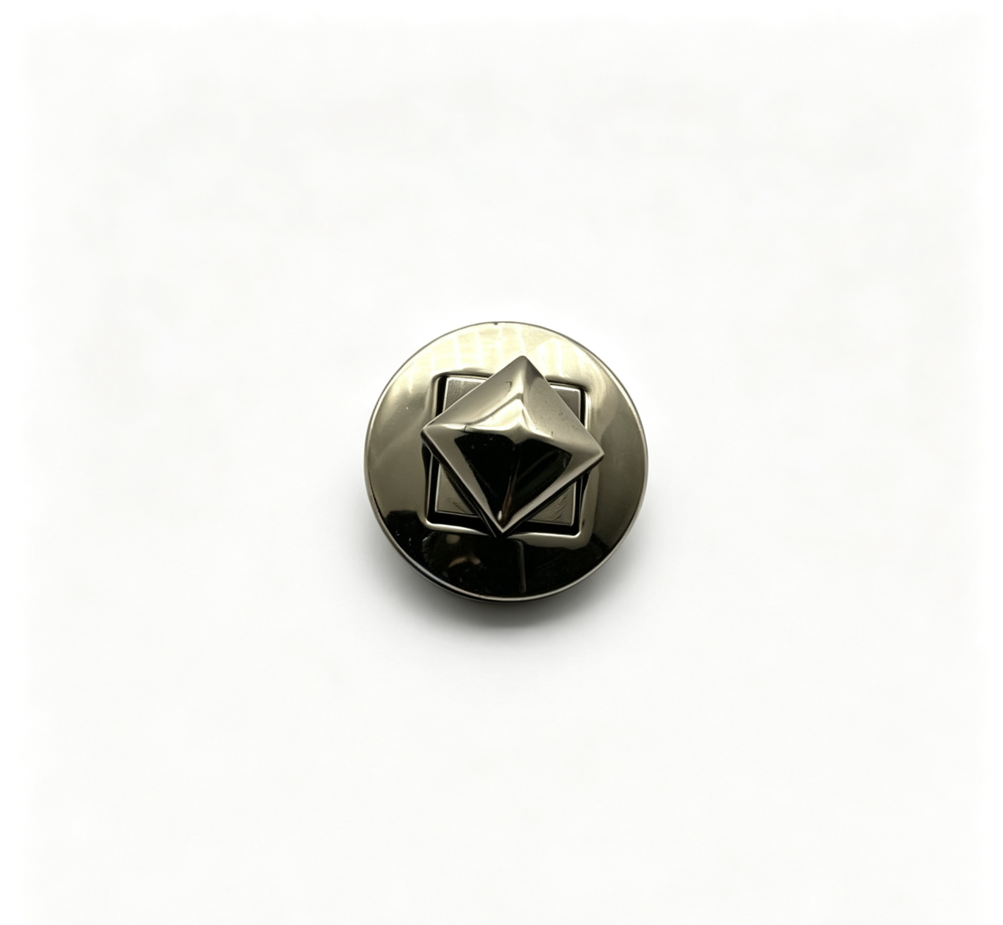 Close-up of a high-polish gunmetal round twist lock featuring a 3D pyramid stud turn mechanism for luxury handbags, custom manufactured by Wahkoi Metal
