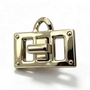 Close-up of a high-polish light gold padlock-style twist lock featuring an openwork frame and top loop for luxury handbags, custom manufactured by Wahkoi Metal