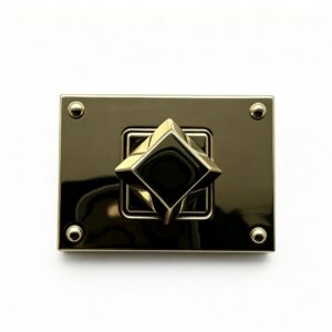 Close-up of a high-polish light gold rectangular twist lock featuring a 3D diamond turn mechanism and corner rivets for luxury handbags, custom manufactured by Wahkoi Metal