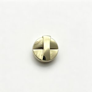 Close-up of a high-polish light gold round geometric cross twist lock for luxury handbags, custom manufactured by Wahkoi Metal