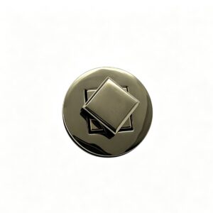 Close-up of a high-polish light gold round twist lock featuring a recessed geometric diamond turn mechanism for luxury handbags, custom manufactured by Wahkoi Metal