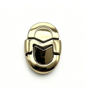 Premium polished gold zinc alloy oval handbag lock with M-shaped clasp, custom manufactured by Wahkoi Metal.