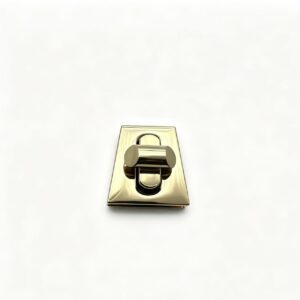 Premium polished gold zinc alloy trapezoid turn lock for luxury handbags, custom manufactured by Wahkoi Metal.