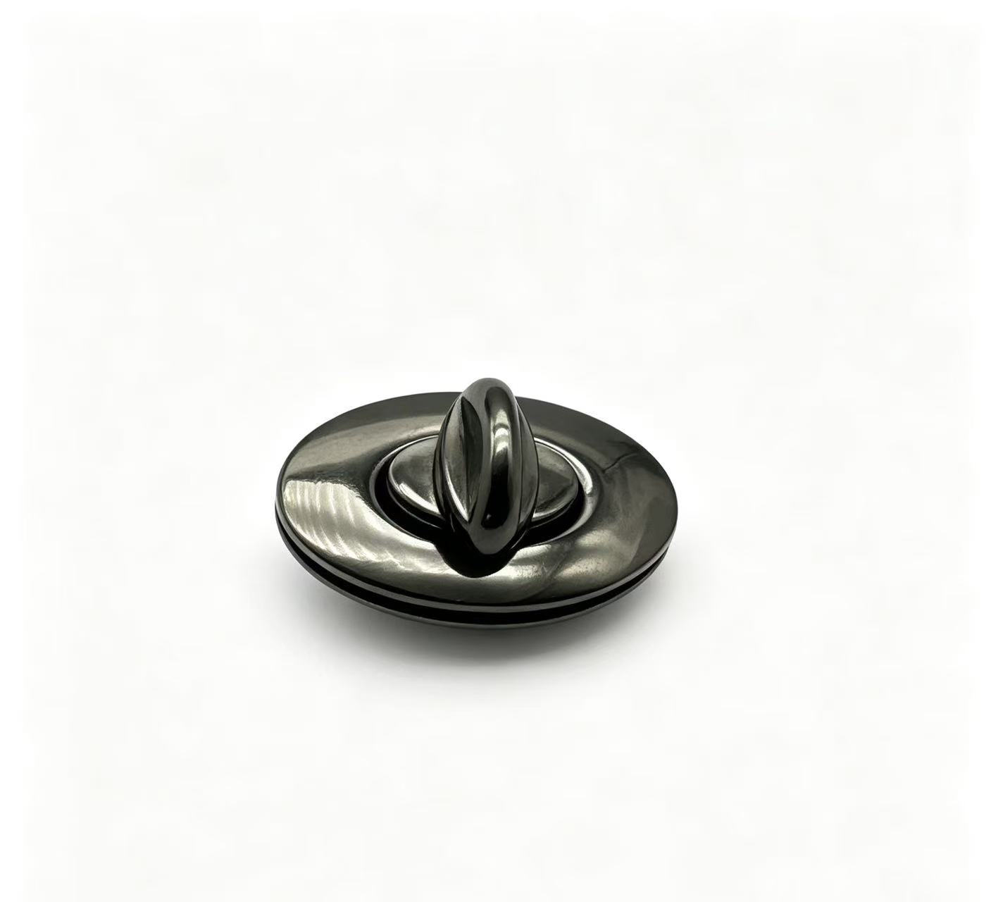 Premium polished gunmetal zinc alloy oval turn lock with pointed twist knob for luxury handbags, custom manufactured by Wahkoi Metal.